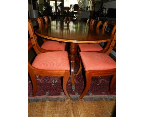 A Regency style mahogany dining suite, comprising a cross-banded D-end extending dining table, raised on twin column supports