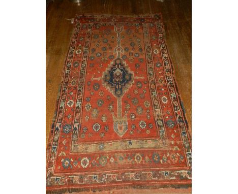 A red ground Kurdish runner, having central medallion on a floral ground, multi-bordered. L: 193cm W: 110cm