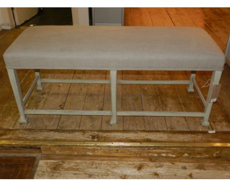 A George III style lined oak window stool, having a stuffover seat, raised on chamfered square legs united by plain stretcher