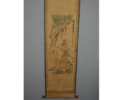 A Chinese scroll, polychrome printed with figures amongst a stylised landscape. W.48cm