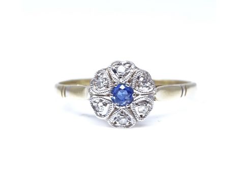 An 18ct gold sapphire and diamond cluster flowerhead ring, set with round sapphire and round single cut diamonds with heart-s