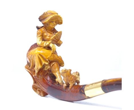 A 19th century Meerschaum pipe, formed as a lady sitting with a Yorkshire Terrier dog, amber mouthpiece with 18ct gold collar