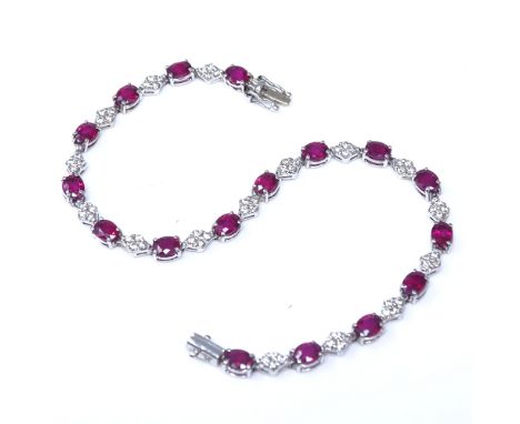 An 18ct white gold ruby and diamond cluster panel line bracelet, maker's marks P and S, hallmarks Edinburgh 2006, bracelet le
