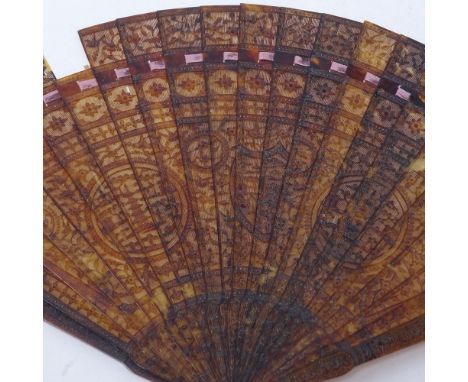 A 19th century Chinese tortoiseshell brise fan, carved and pierced guards with main temple decorated panels, length 19.5cm Go