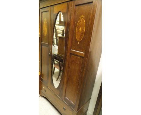 An Edwardian mahogany single mirror door wardrobe with drawer below and a 1920's mahogany bow fronted display cabinet on claw