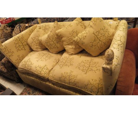 A Knoll style sofa with yellow upholstery with green tree decoration