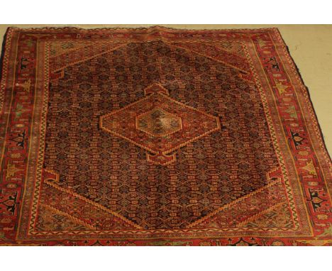 A modern Caucasian carpet, the central panel set with lozenge shaped medallion on a blue ground with all-over stylised floral