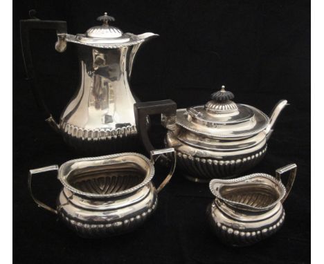 An Edwardian silver three piece tea set of rectangular bellied form with reeded base, comprising teapot with ebonised finial 