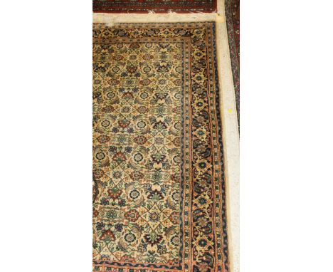 A modern Persian style carpet, the central panel set with all-over floral decoration on a cream ground, within a stepped flor