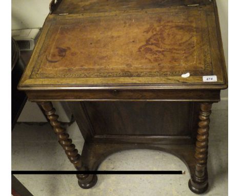 A Victorian rosewood Davenport desk, the sloping fall with tool and guilded leather insert opening to reveal a satinwood line