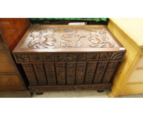 A carved mahogany blanket chest, with Mayan figures and secret drawers