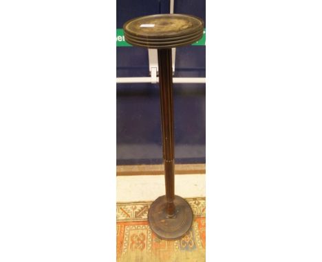A mahogany plant stand with circular dish top on a stop fluted pedestal to circular base and lions paw feet