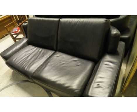 A black leather two seat sofa on chrome legs