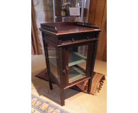 A Victorian mahogany bijouterie cabinet in the Chippendale taste, three quarter gallery to top over fretwork decorated drawer