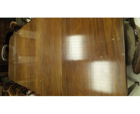 An early 19th Century mahogany D-end dining table with plain mahogany top, the central section as a gate-leg table with two s