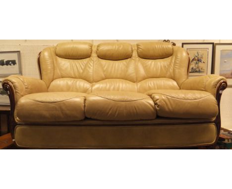 A modern cream leather upholstered three seat sofa and pair or matching arm chairs and pouffe