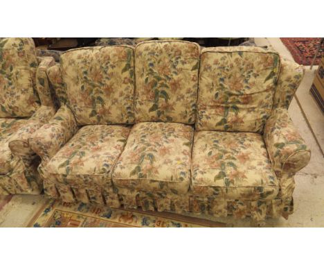 A Laura Ashley living room suite comprising three seat sofa, single arm chair and footstool and two seat sofa and footstool i