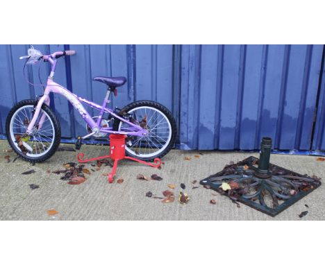 A child's Secret Concept bike, a cast iron parasol stand and a Christmas tree stand
