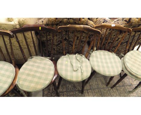 A set of six stick back kitchen chairs with circular seats, raised on turned and ringed legs