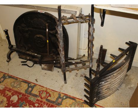 A cast iron fire back bearing date 1571, together with fire basket, wrought iron dogs and fire tools including two Cotswold s