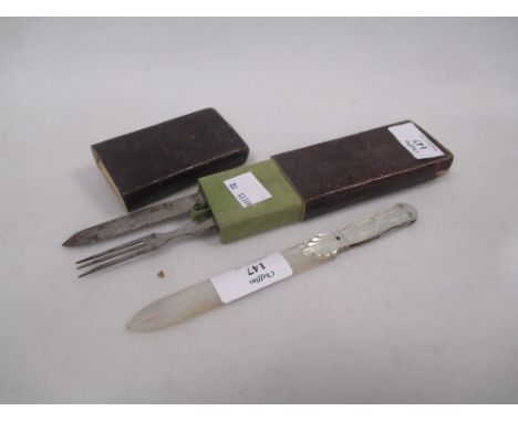 A travelling cased knife and fork and a mother of pearl combined paper and penknife with another blade folding into the handl