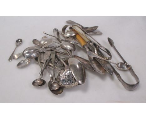 A mixed group of silver flatware, various dates and makers, including: three butter knives, five salt spoons, caddy spoon, th