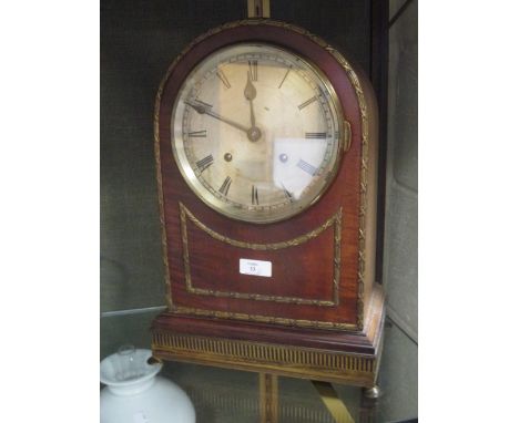 A late Victorian carved oak aneroid barometer, (replacement thermometer), and a faded mahogany dome top bracket clock with go