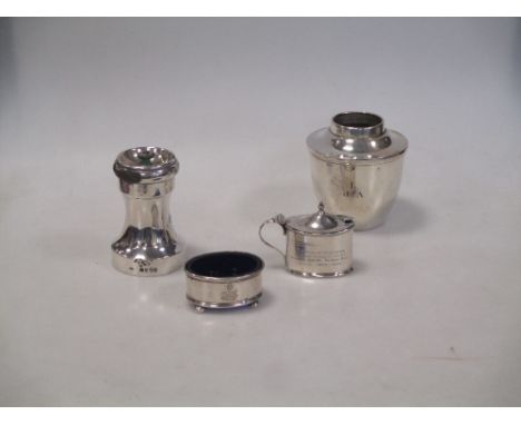 A silver pepper grinder, London 1878, together with a table salt and another, and a silver section of an oil lamp (4)  