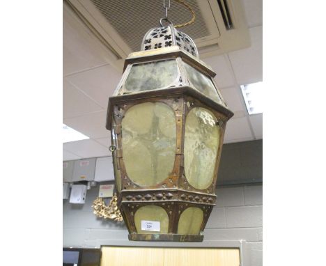 An ironwork lantern with yellow glass  