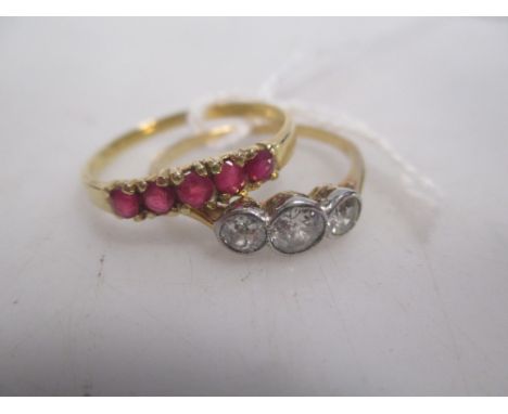 A three stone diamond ring and a ruby ring (2)  