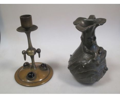 An Art Nouveau spelter jug after Garnier and a brass candlestick set with agate cabochons  
