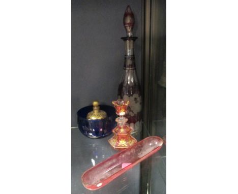 Two Bohemian glass scent bottles, a ruby overlay decanter, a blue finger bowl and a cranberry pen tray  