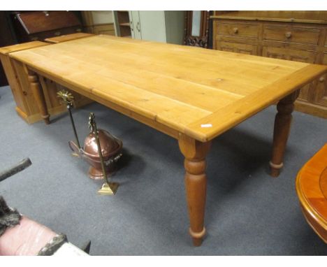 A large bespoke light oak dining table with cleated ends on turned legs, 245 x 103cm  