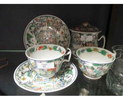 A pair of Chinese tea cups and saucers en suite with a covered two handled bowl  