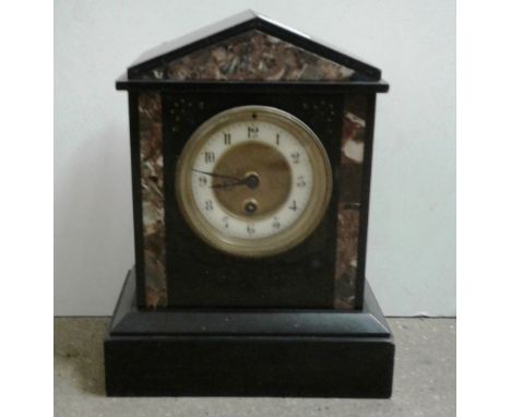 A late Victorian black slate mantel clock with brass and enamel dial