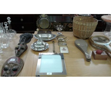 A quantity of metalware to include a brass gong; a door knocker; a silver plated muffin dish etc.