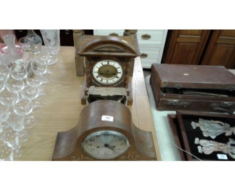 An oak cased mantel clock with enamel dial together with a two hole mahogany cased mantel clock