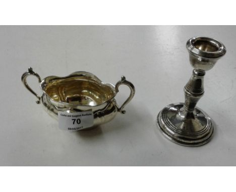 A silver sugar bowl together with a silver dwarf candlestick