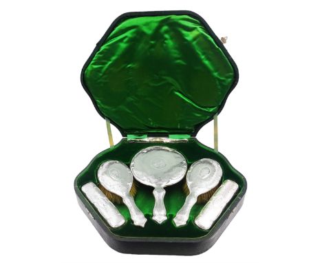 Edwardian silver mounted six piece dressing table set, comprising hand mirror, two hair brushes, two clothes brushes and comb