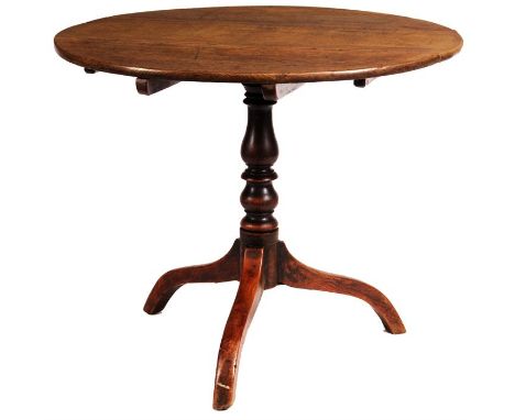 An early George III Oak tilt-top SUPPER TABLE with ring tuned baluster stem and arched tripod base&nbsp;91cm diameter&nbsp;