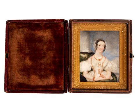 An early Victorian half length PORTRAIT on Ivory of a seated young Lady in an ornate glazed gilt brass frame with Morrocan le