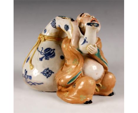 An unusual Chinese glazed Stoneware gouard shaped TEAPOT with seated figure of a man, the ribbon tied body decorated various 