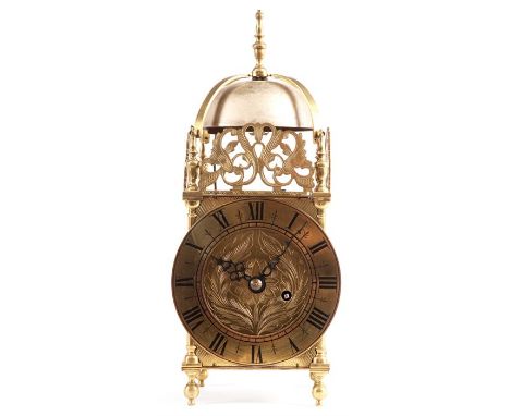 A late 19th Century Brass LANTERN CLOCK of 17th Century design with pierced frets and strapped bell above a roman chapter rin