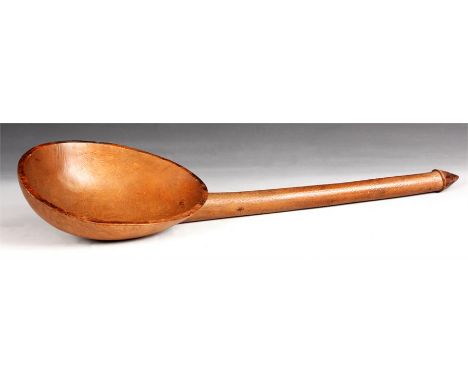 A 19th Century Continental large Treen Ware LADLE with shallow ovoid bowl and turned pointed handle&nbsp;57.5cm overall