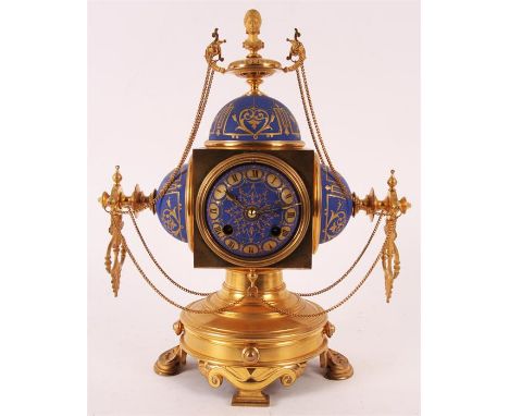 A stylish 19th Century Ormolu and Blue Porcelain French MANTEL CLOCK with pedestal base and ornate feet supporting a cube sha