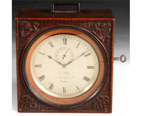 E. WHITE. 20 COCKSPUR St. LONDON. An unusual mid/late 19th Century&nbsp;CHRONOMETER type DESK CLOCK in carved oak fitted case