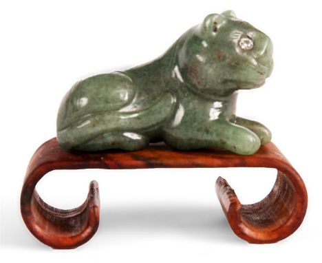 A carved Jade CAT with jewelled eyes standing on walnut base 63mm long