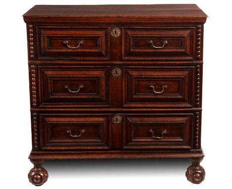 A late 17th Century joined Oak CHEST with panelled sides enclosing three graduated moulded front long drawers enclosed by spl