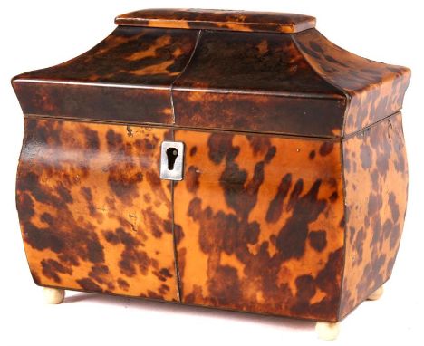 An early Victorian mottled Tortoiseshell sarcophagus pagoda top TEA CADDY with divided lidded interior and small ivory bun fe