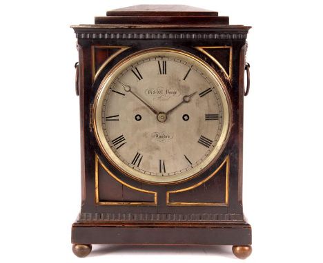 G &amp; W YONGE STRAND LONDONA Regency Ebonised chamfer-top BRACKET CLOCK of small size with brass ring handles and side fret